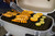 GrillGrate® for PK360, grilling salmon, lemon, and lime slices on a portable grill with grill grate panels.