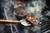 GrillGrate® for The Original & PK300 Grill, a close-up of meat steaks being grilled on the grate with visible grill marks and smoke.