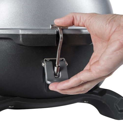 PK Grills PKGO with FlipKit, close-up of a hand attaching the FlipKit to the main grill body with a screwdriver.