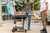 PK Grills The All New Original PK300AF Grill & Smoker - Teal, outdoor scene with people grilling and socializing on a patio.