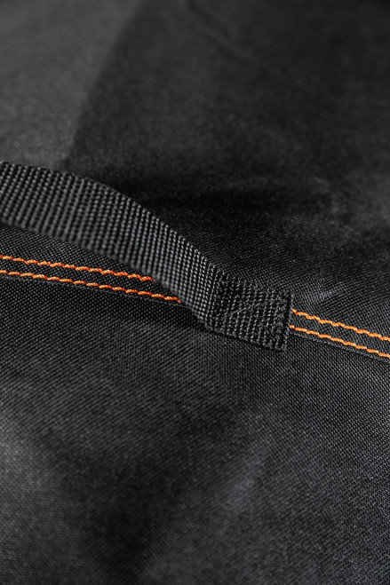 PK Grills The All New PK360 Slim Cover, close-up view of black fabric material with orange stitching and a black handle.