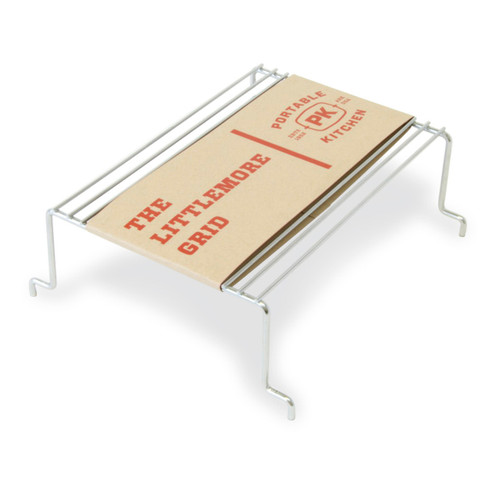 PK Grills The Littlemore Grid for PK Grills, a replacement metal grill rack with a cardboard label on top, designed for outdoor grilling and cooking.