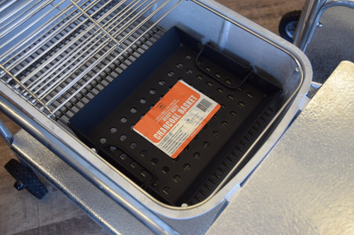 PK Grills The PK Heavy Duty Charcoal Basket, black perforated metal charcoal basket inside a grill.