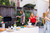 PK Grills The PK360 Grill & Smoker - Classic Silver, outdoor barbecue setup with people grilling and socializing in a backyard.